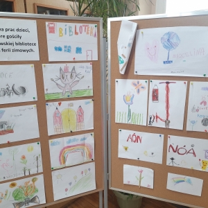 W bibliotece. Tablice korkowe. Na nich przypięte prace plastyczne.