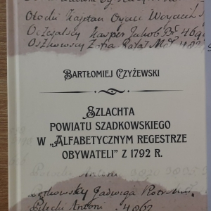 Książka. Okładka książki w kolorach beżu. 