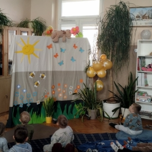 W bibliotece. Udekorowana scena. Dzieci oglądają kukiełkowy teatrzyk.