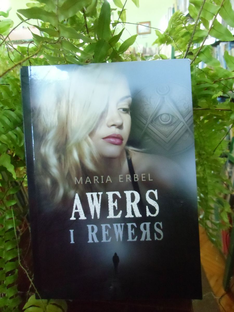 Książka "Awers i rewers" - Marii Erbel. W tle zielony kwiat